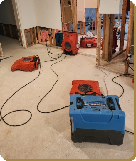 water restoration fans and machines in a room with drywall removed