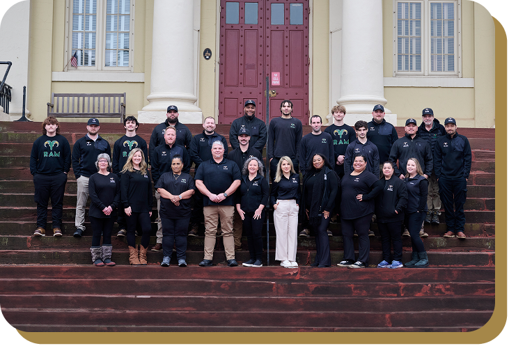 Team standing in front of RAM Restoration trucks
